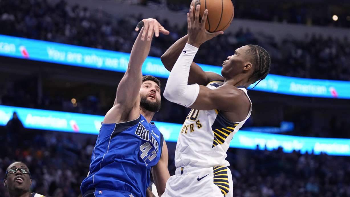 Indiana Pacers guard Bennedict Mathurin (00) shoots against Dallas Mavericks' Maxi Kleber (42) during the first half of an NBA basketball game Tuesday, March 5, 2024, in Dallas.