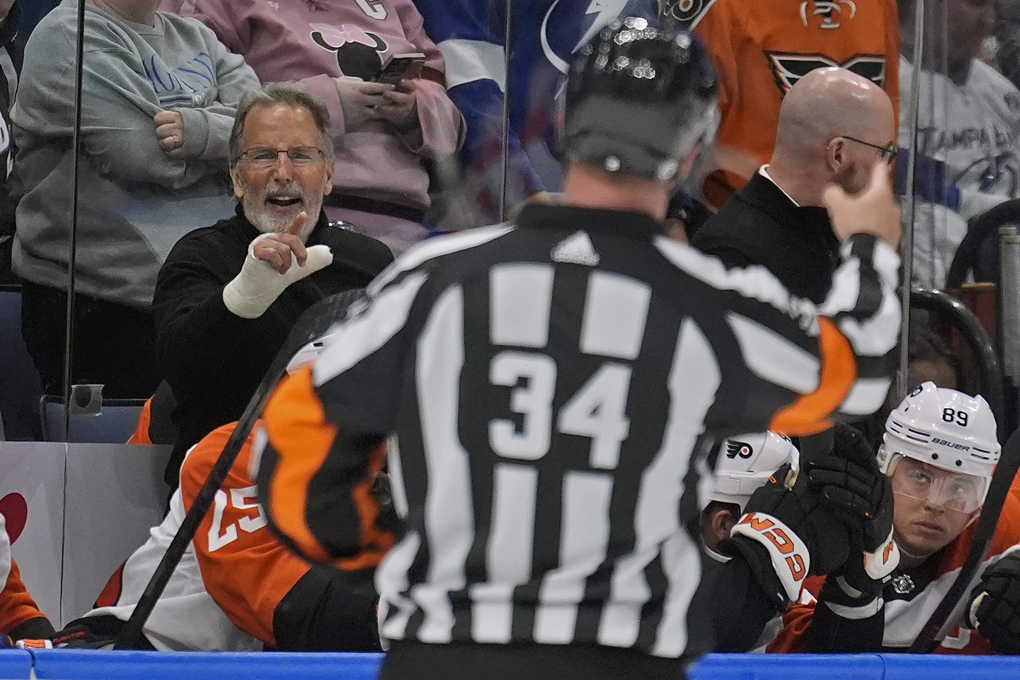 Philadelphia Flyers head coach John Tortorella, left, yells at referee Brad Meier (34) after being kicked out the game against the Tampa Bay Lightning during the first period of an NHL hockey game Saturday, March 9, 2024, in Tampa, Fla.