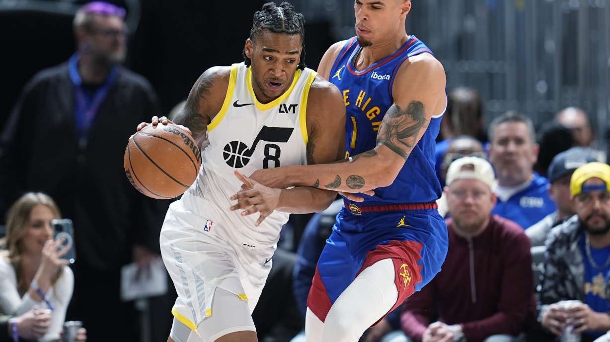 Utah Jazz forward Brice Sensabaugh, left, drives to the basket as Denver Nuggets forward Michael Porter Jr. defends during the first half of an NBA basketball game Saturday, March 9, 2024, in Denver.