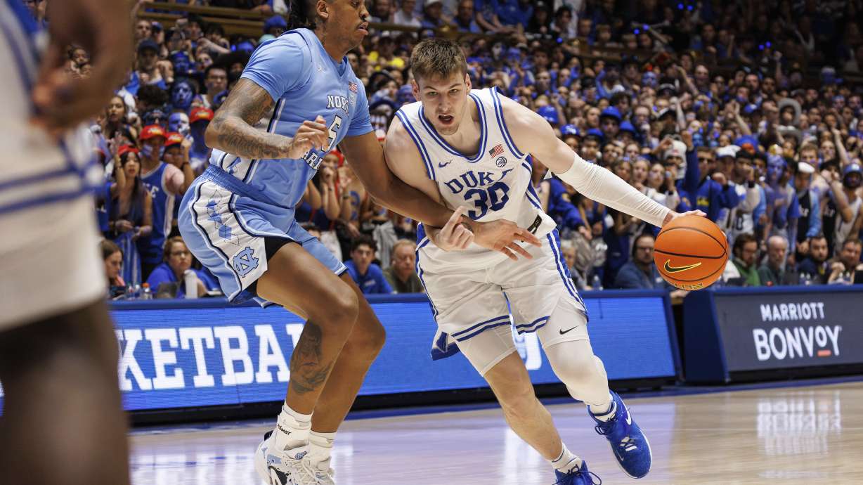 Duke's Kyle Filipowski (30) handles the ball as North Carolina's Armando Bacot (5) defends during the second half of an NCAA college basketball game in Durham, N.C., Saturday, March. 9, 2024.
