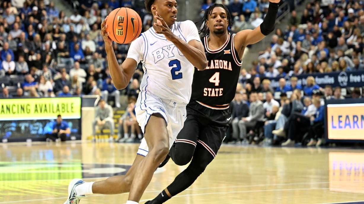 Brigham Young Cougars guard Jaxson Robinson (2) drives on Oklahoma State Cowboys guard Jarius Hicklen (4) as BYU and Oklahoma State play at the Marriott Center in Provo on Saturday, March 9, 2024.