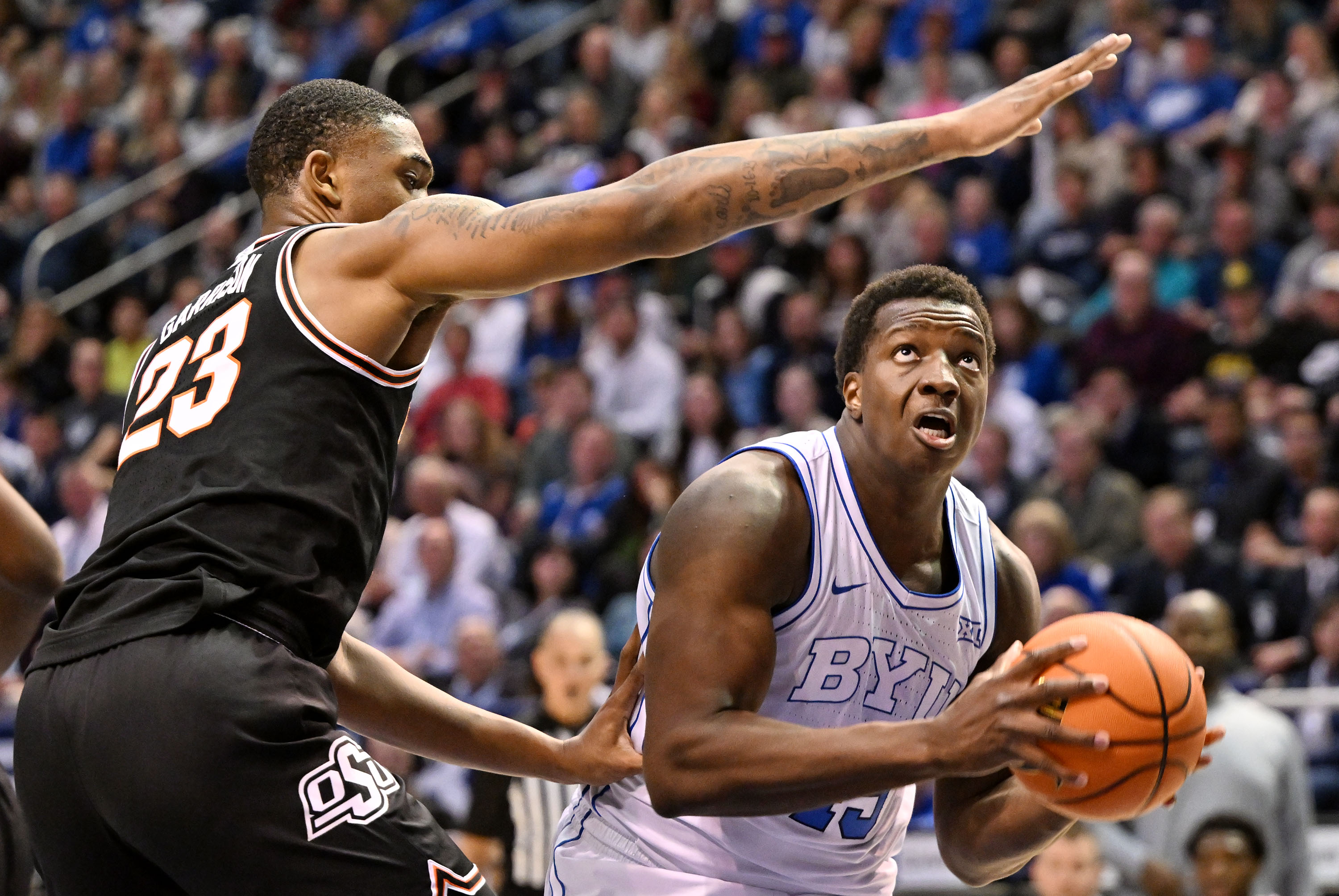Oklahoma State center Brandon Garrison (23) defends Brigham Young forward Fousseyni Traore (45) under the hoop as BYU and Oklahoma State play at the Marriott Center in Provo on Saturday, March 9, 2024.