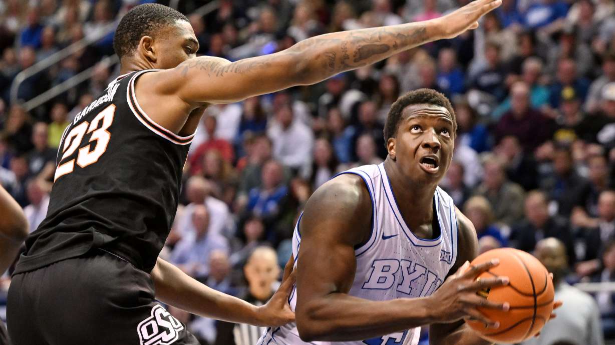 Oklahoma State center Brandon Garrison (23) defends Brigham Young forward Fousseyni Traore (45) under the hoop as BYU and Oklahoma State play at the Marriott Center in Provo on Saturday, March 9, 2024.