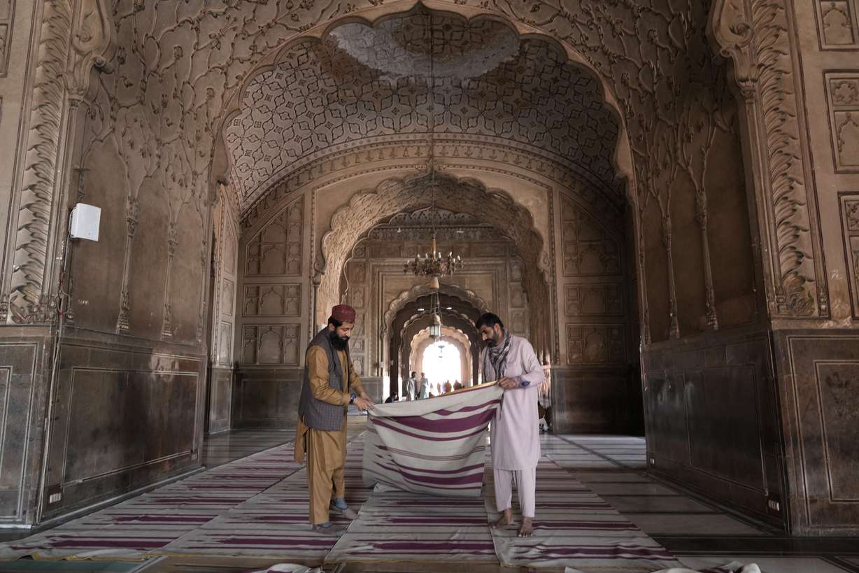 Workers clean the carpet in the historical 'Badshahi' mosque in preparation for the upcoming Lahore, Pakistan, Saturday.