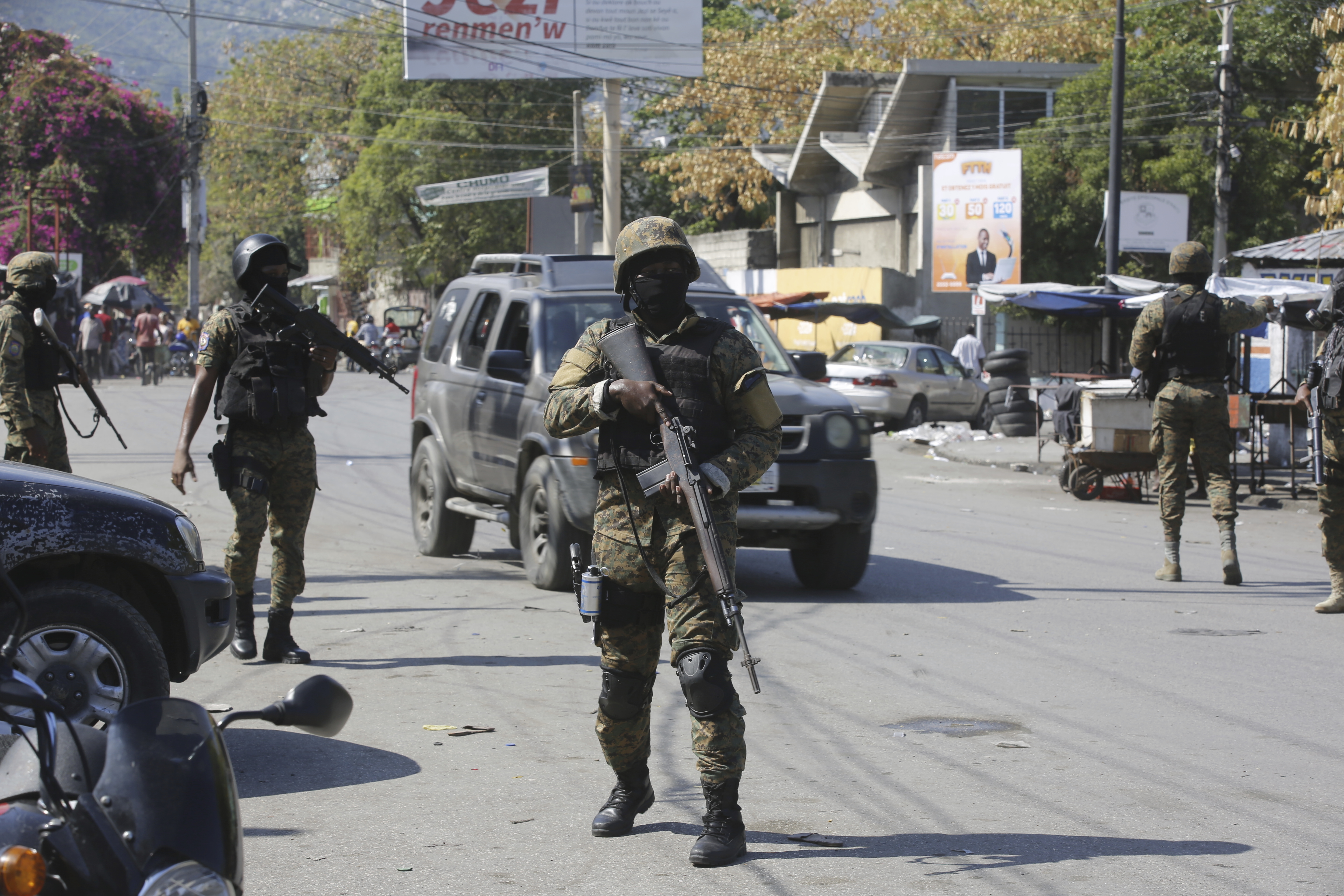 Members of the General Security Unit of the National Palace, USGPN, set up a security perimeter around one of the three downtown stations after police fought off an attack by gangs the day before, in Port-au-Prince, Haiti, Saturday.