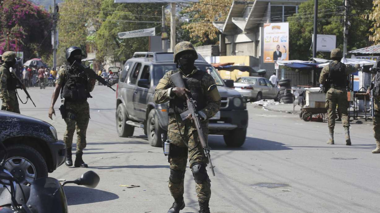 Members of the General Security Unit of the National Palace, USGPN, set up a security perimeter around one of the three downtown stations after police fought off an attack by gangs the day before, in Port-au-Prince, Haiti, Saturday.