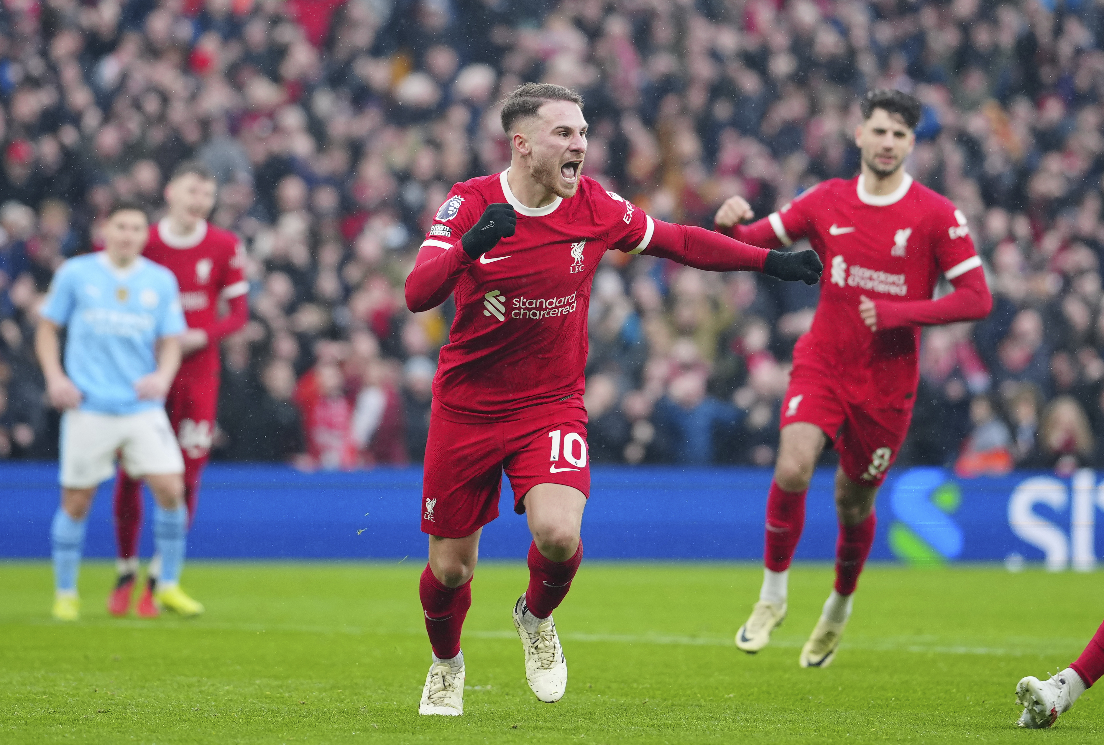 Liverpool's Alexis Mac Allister celebrates after scoring a penalty, his side's first goal during the English Premier League soccer match between Liverpool and Manchester City, at Anfield stadium in Liverpool, England, Sunday, March 10, 2024.