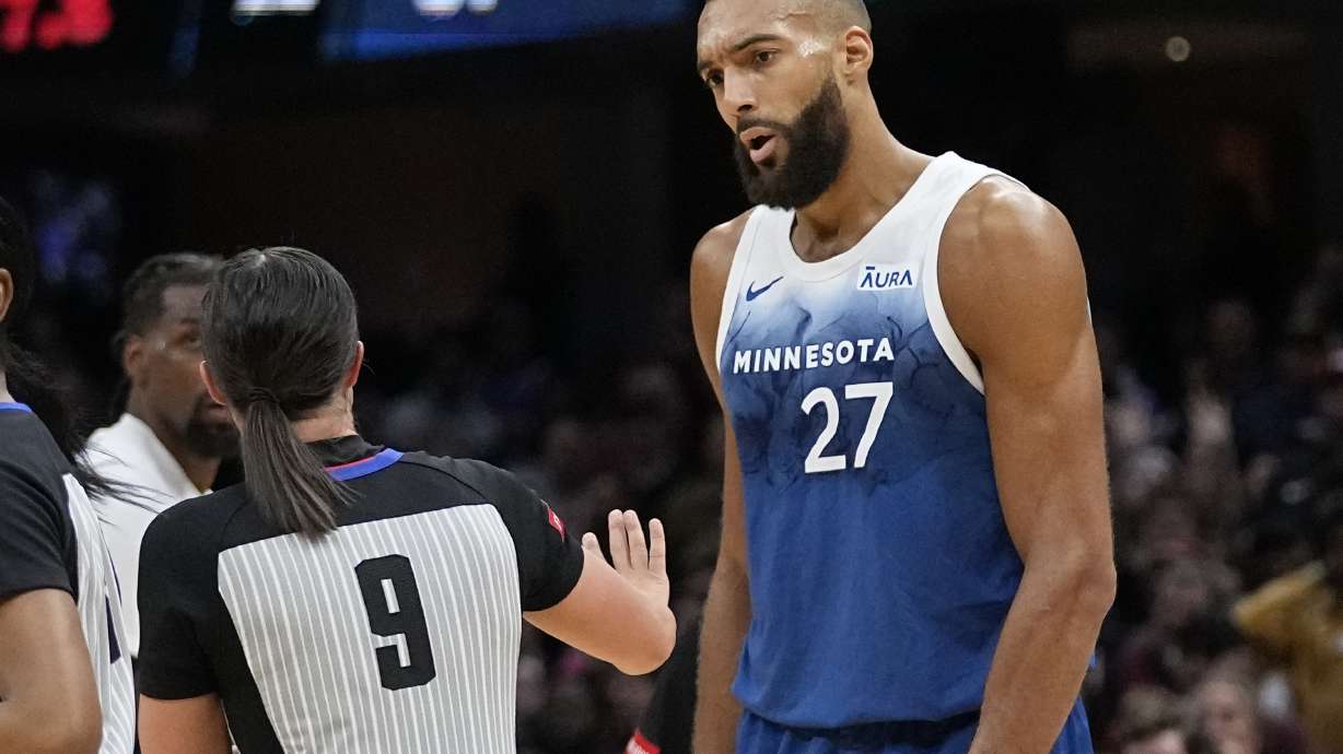 Minnesota Timberwolves center Rudy Gobert (27) talks with referee Natalie Sago (9) after being called for a technical foul in the second half of an NBA basketball game against the Cleveland Cavaliers, Friday, March 8, 2024, in Cleveland.