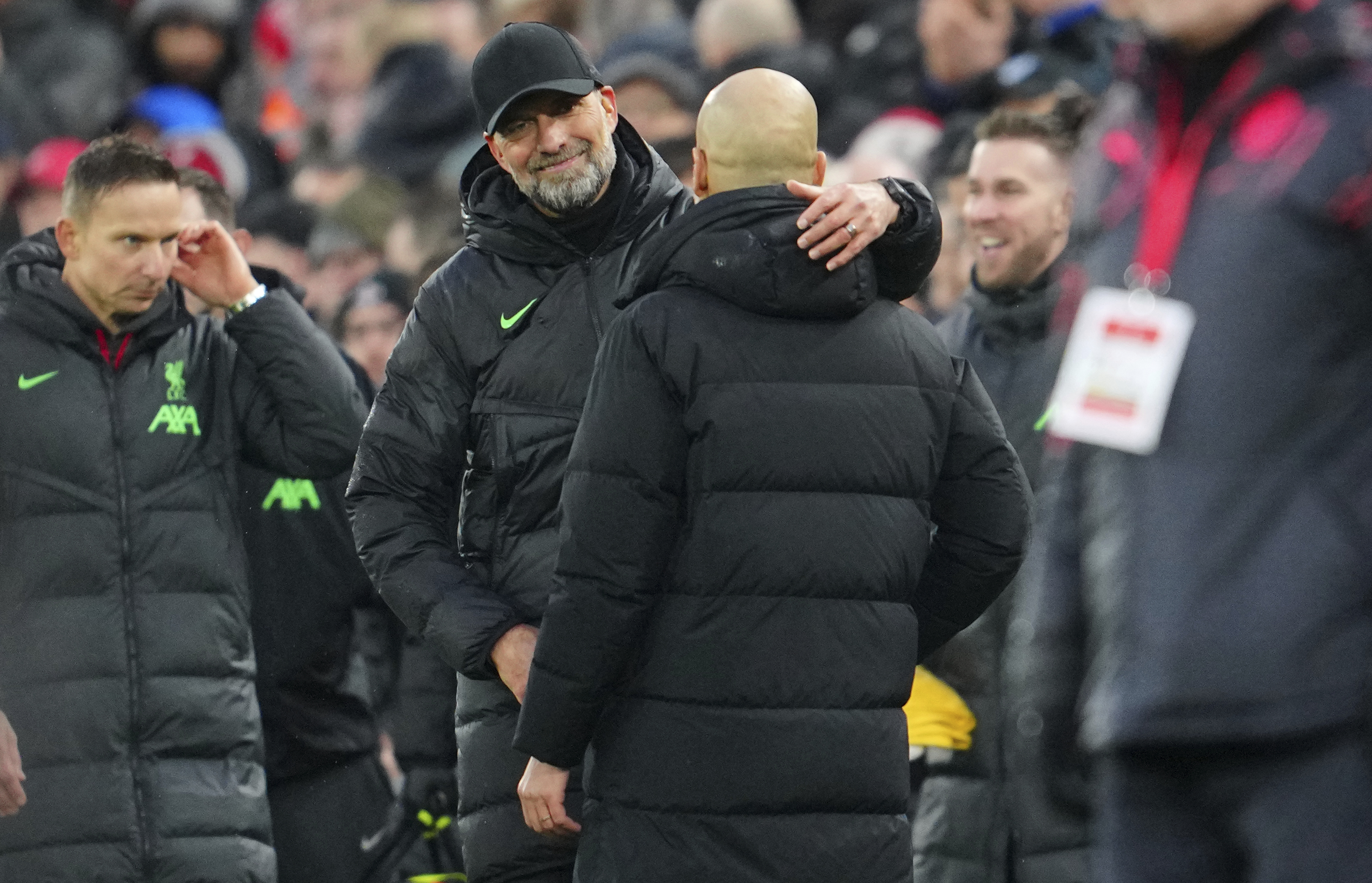 Liverpool's manager Jurgen Klopp, left, hugs Manchester City's head coach Pep Guardiola after the English Premier League soccer match between Liverpool and Manchester City, at Anfield stadium in Liverpool, England, Sunday, March 10, 2024. The match ended 1-1. 