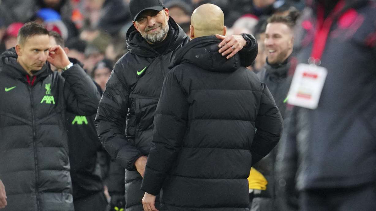 Liverpool's manager Jurgen Klopp, left, hugs Manchester City's head coach Pep Guardiola after the English Premier League soccer match between Liverpool and Manchester City, at Anfield stadium in Liverpool, England, Sunday, March 10, 2024. The match ended 1-1.