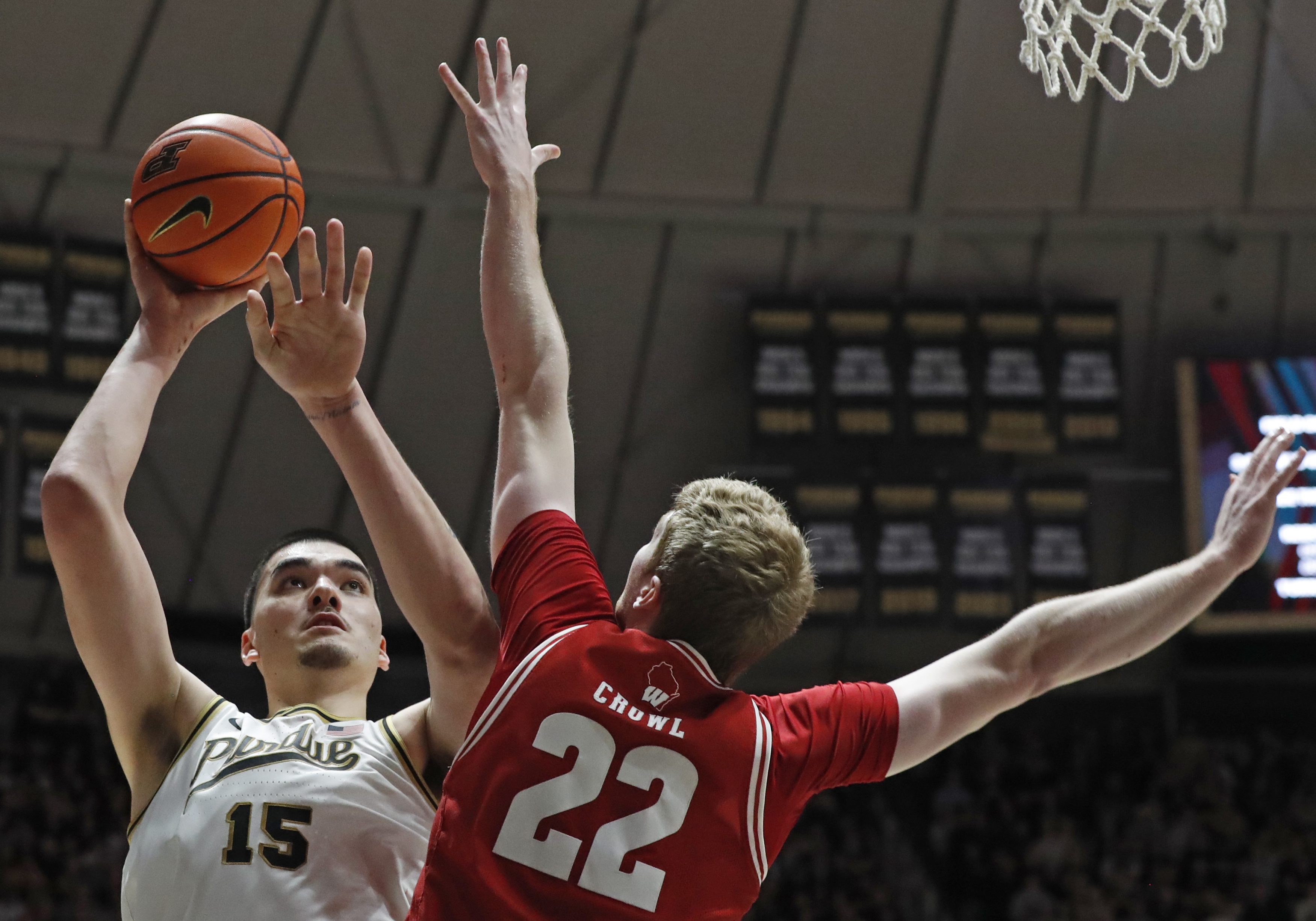 Purdue center Zach Edey (15) shoots the ball over Wisconsin forward Steven Crowl (22) during the NCAA men's basketball game, Sunday, March 10, 2024, at Mackey Arena in West Lafayette, Ind. Purdue won 78-70. 