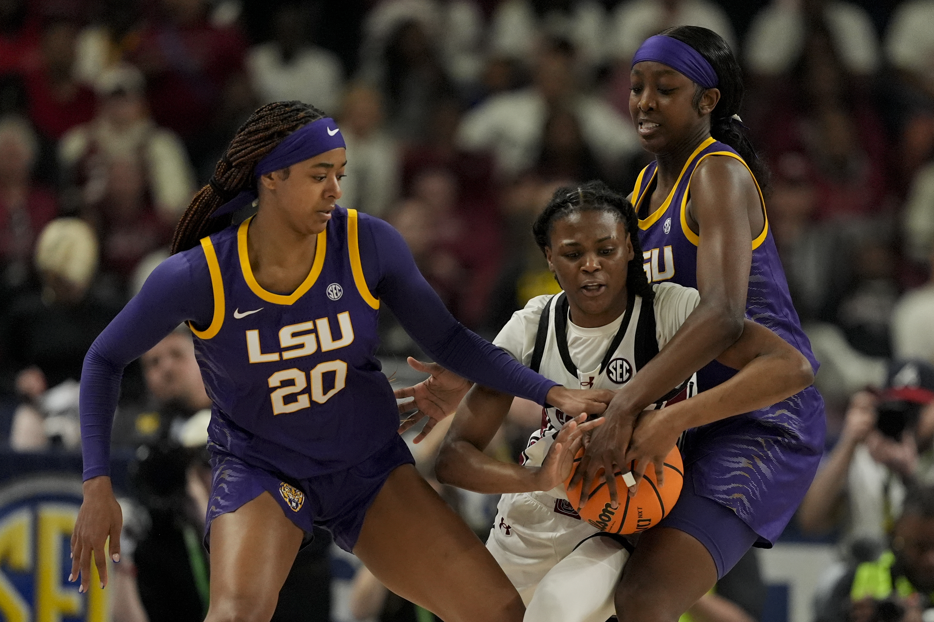 South Carolina guard MiLaysia Fulwiley vies for the ball with LSU guard Janae Kent, left, and guard Flau'jae Johnson during the first half of an NCAA college basketball game at the Southeastern Conference women's tournament final Sunday, March 10, 2024, in Greenville, S.C. 