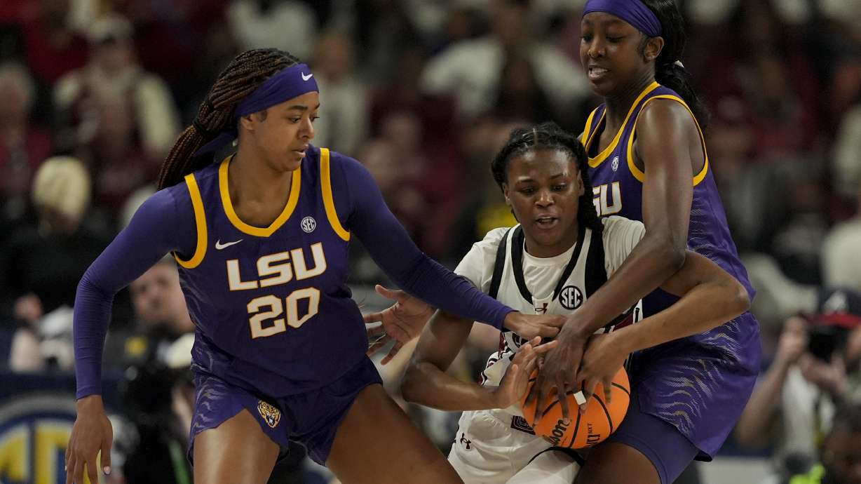 South Carolina guard MiLaysia Fulwiley vies for the ball with LSU guard Janae Kent, left, and guard Flau'jae Johnson during the first half of an NCAA college basketball game at the Southeastern Conference women's tournament final Sunday, March 10, 2024, in Greenville, S.C.