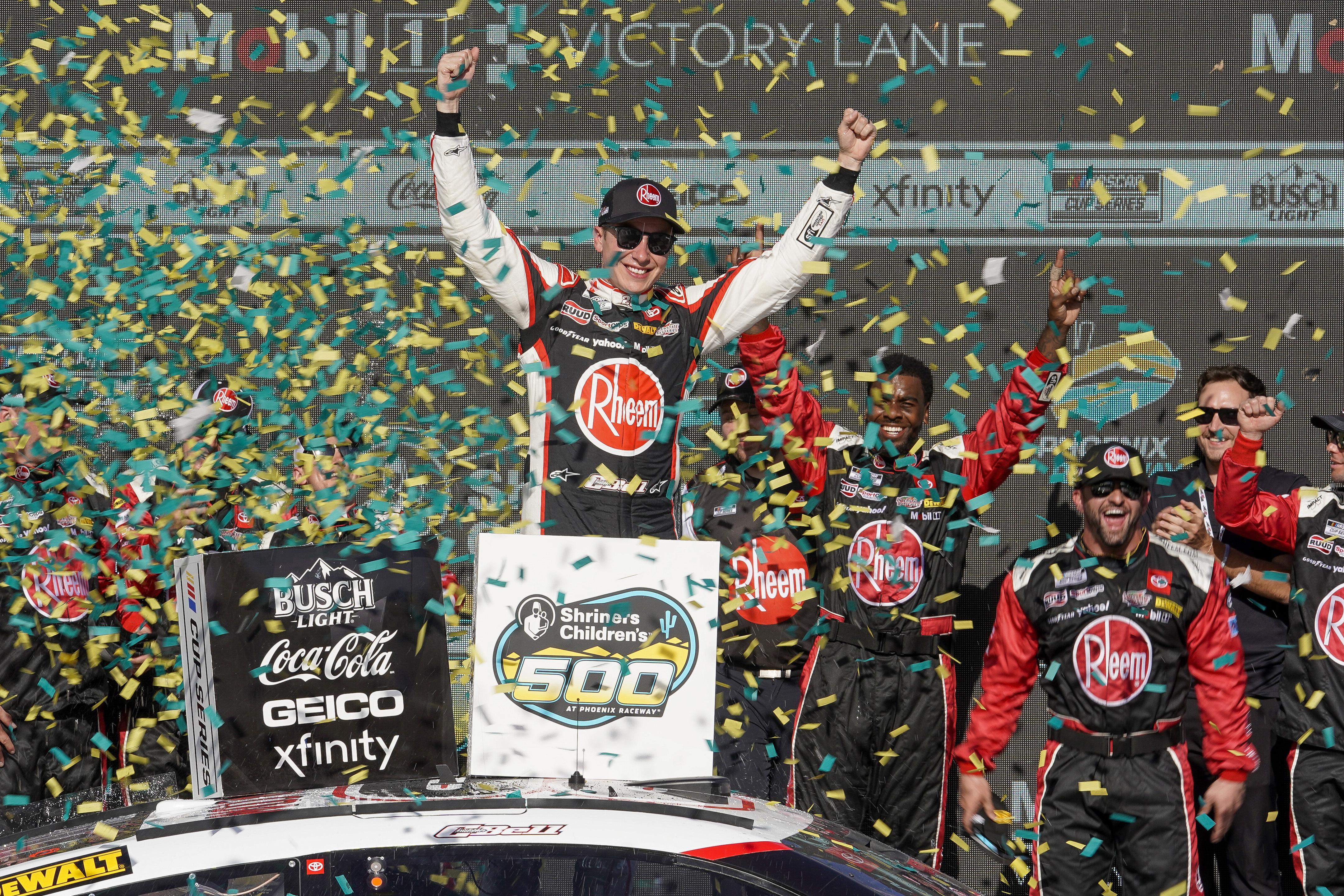 Christopher Bell, center, celebrates after his NASCAR Cup Series auto race win at Phoenix Raceway, Sunday, March 10, 2024, in Avondale, Ariz.