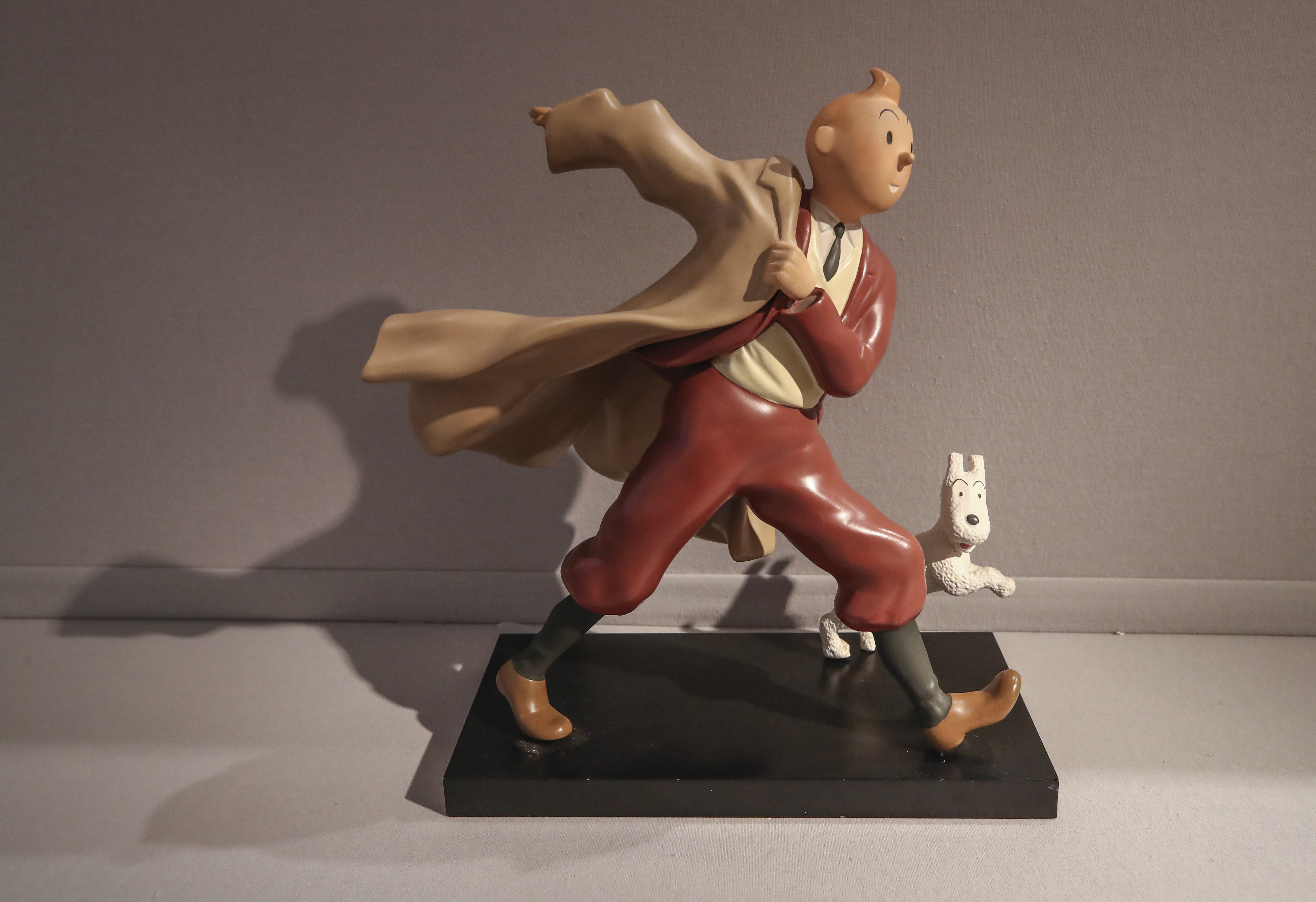 FILE - A 1988 polychrome resin sculpture of the comic character Tintin and his dog snowy from the 1941 "The Crab with the Golden Claws" album drawn by Belgian creator Herge is displayed at the Artcurial auction house in Paris, on Jan. 13, 2021. The Belgium international players taking part in the Euro soccer tournament this summer could well resemble a world-famous reporter. According to leaks on various specialized websites, the Belgium Euro 2024 away kit is a tribute to Tintin. The Belgian federation is set to unveil the new kit on Thursday March 14, 2024 during a press conference at the Hergé Museum.
