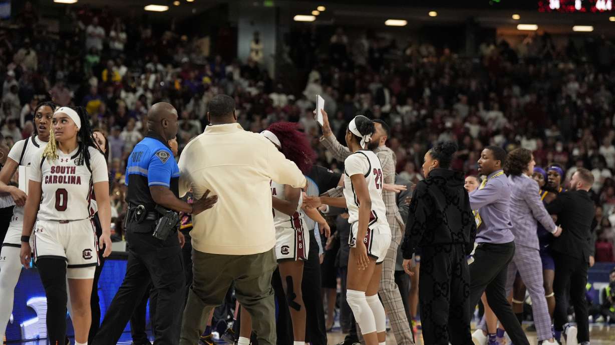 The benches clear during a player altercation during the second half of an NCAA college basketball game against LSU at the Southeastern Conference women's tournament final Sunday, March 10, 2024, in Greenville, S.C.