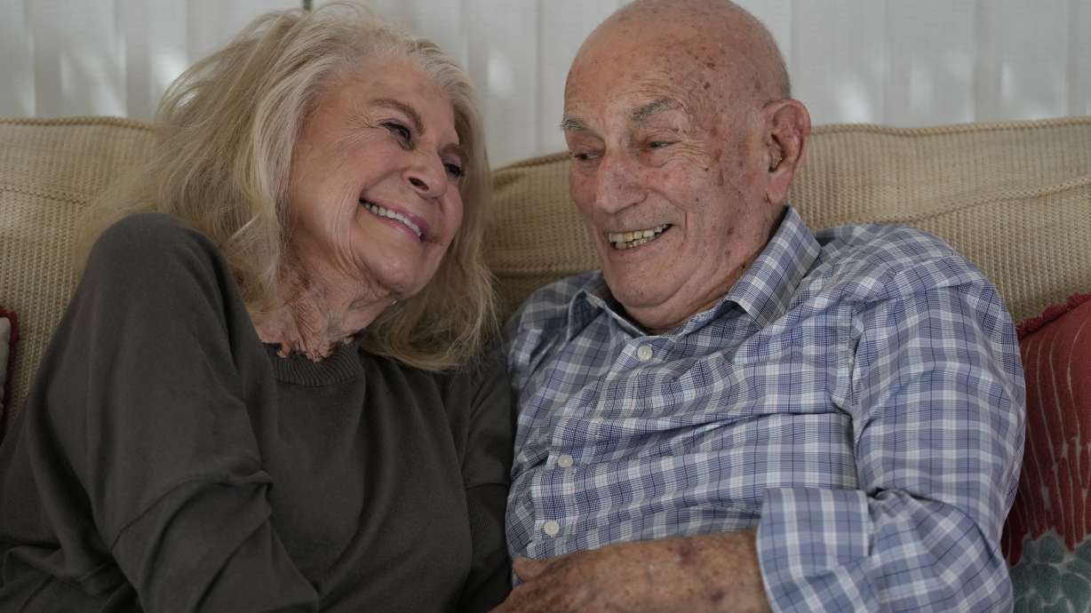 World War II veteran Harold Terens, 100, right, and Jeanne Swerlin, 96, share a laugh as they speak during an interview, Feb. 29, in Boca Raton, Fla. Terens will be honored by France as part of the country's 80th anniversary celebration of D-Day.