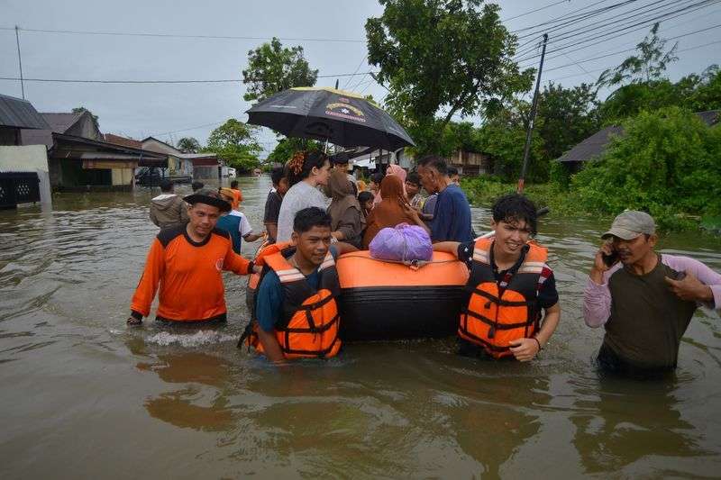 Local Disaster Management Agency officers use an inflatable boat to evacuate locals at a residential area affected by floods due to heavy rains, in Padang, West Sumatra province, Indonesia, March 8.
