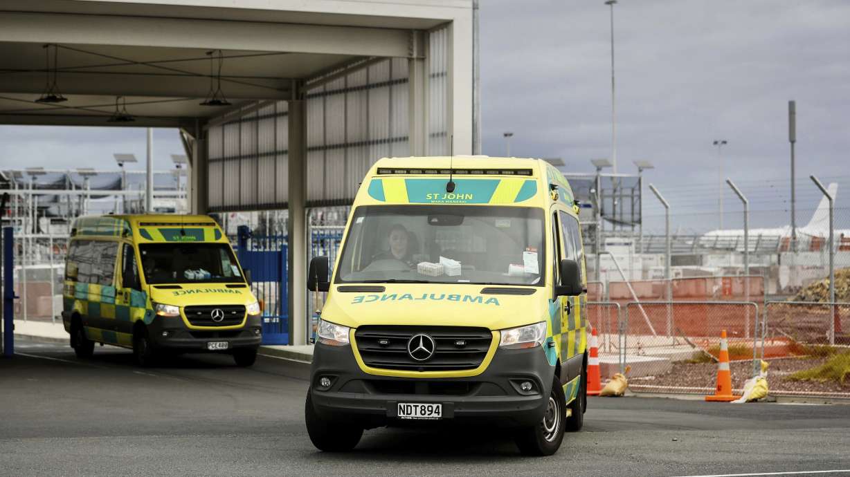 Ambulances leave Auckland International Airport in Auckland, New Zealand, Monday. More than 50 people were injured after what officials described as a "technical event" on a Chilean plane.