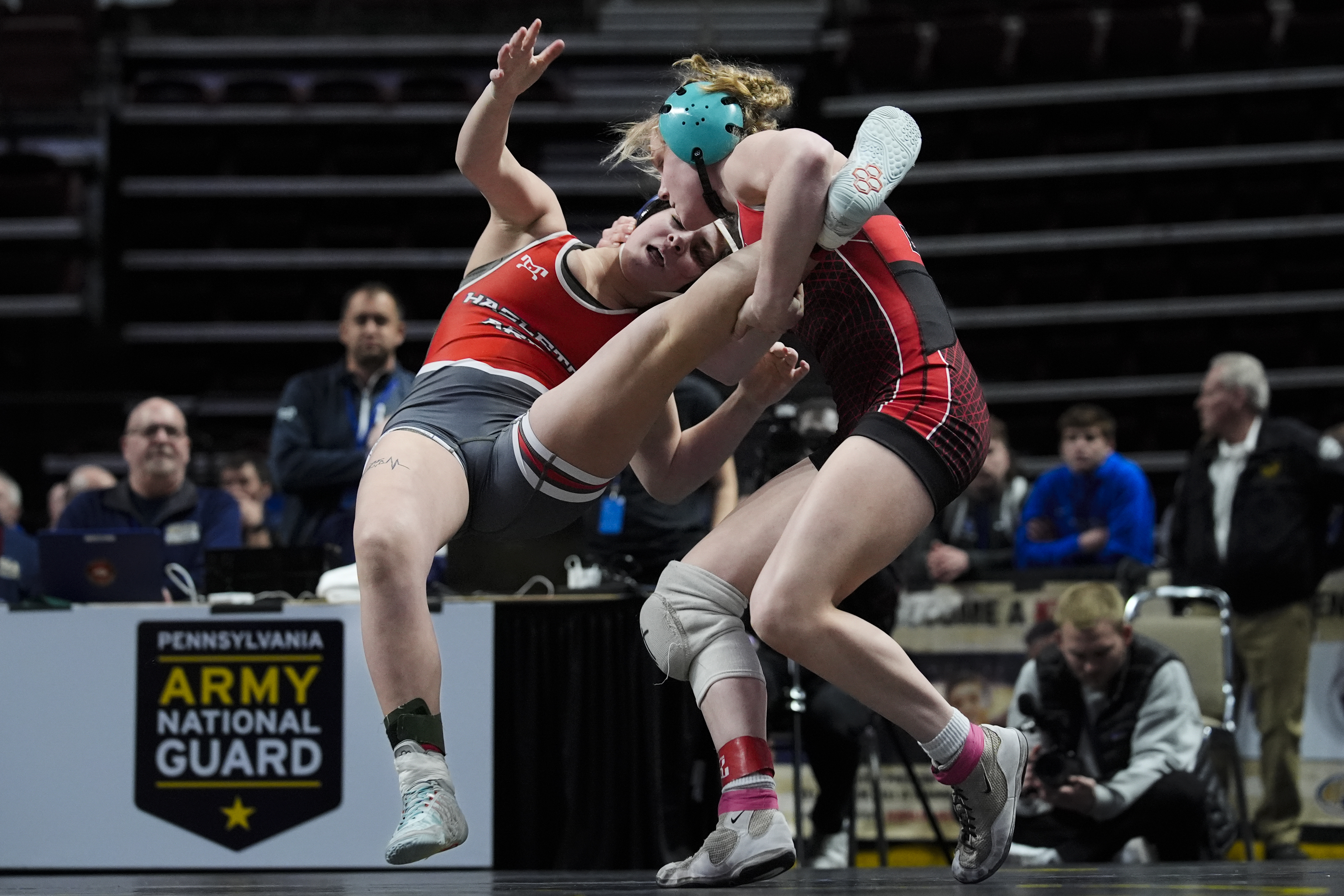 Easton's Aubre Krazer, right, takes down Hazleton Area's Miah Molinaro, left, during the first found of the PIAA High School Wrestling Championships in Hershey, Pa., Thursday, March 7, 2024. Girls’ wrestling has become the fastest-growing high school sport in the country. 