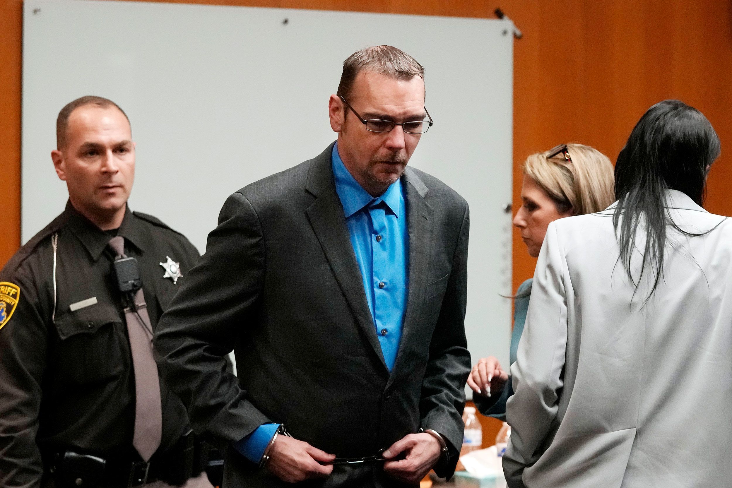James Crumbley is escorted out of the Oakland County courtroom Friday in Pontiac, Mich. A detective testified at his manslaughter trial Tuesday.