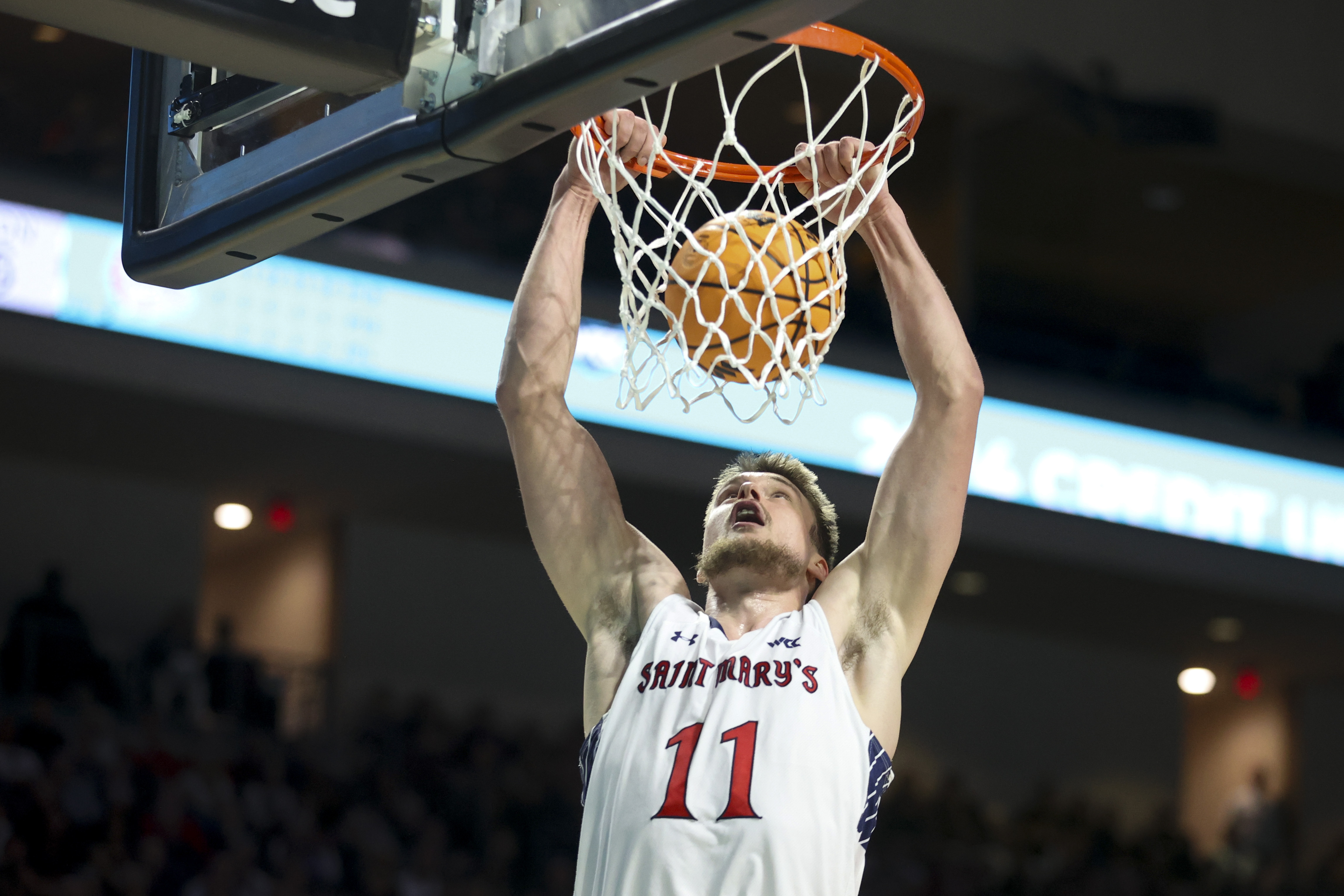 Saint Mary's center Mitchell Saxen (11) dunks the ball against Gonzaga during the first half of an NCAA college basketball game in the championship of the West Coast Conference tournament Tuesday, March 12, 2024, in Las Vegas. 