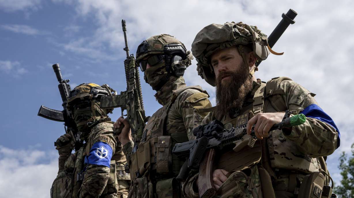Fighters of Russian Volunteer Corps stand not far from the Ukraine-Russia border in Sumy region, Ukraine, on May 24, 2023. Fighters from Ukraine attempted to cross into a Russian town near the border, the governor of Russia’s Kursk region, Roman Starovoit, said Tuesday.
