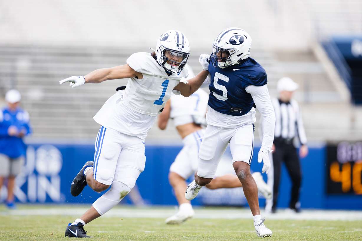 BYU Cougars wide receiver Keanu Hill (1) runs a route against Cougars defensive back D'Angelo Mandell (5) during the annual BYU Blue vs. White scrimmage at LaVell Edwards Stadium in Provo on Friday, March 31, 2023.