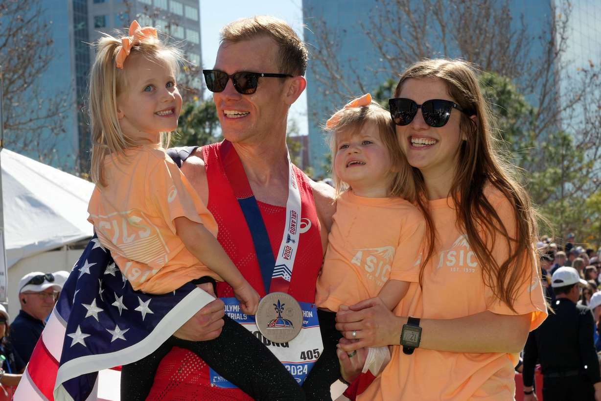 Clayton Young poses with his family after achieving his dream of making the Olympic team in Orlando, Fla. on Feb. 3.