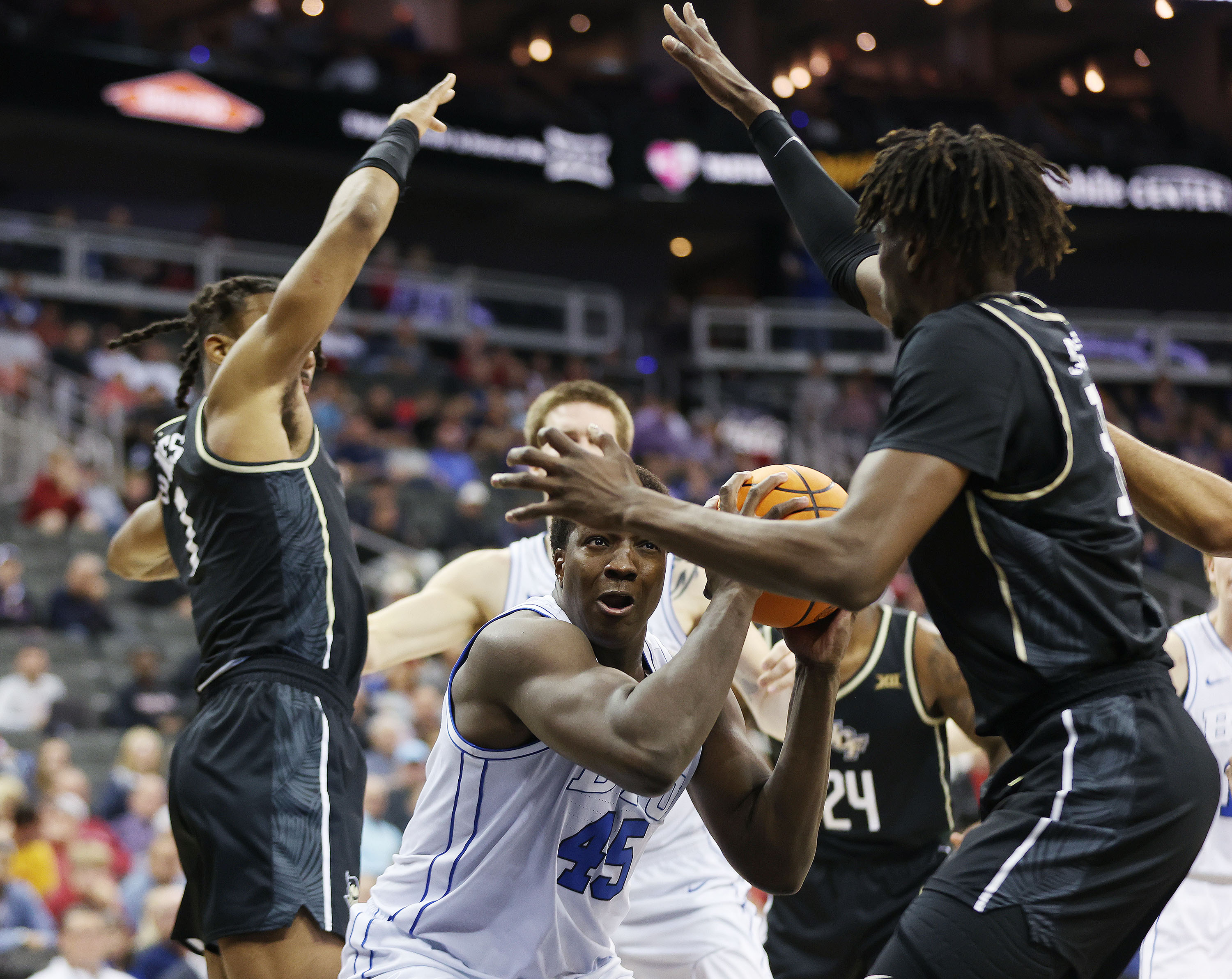 Brigham Young forward Fousseyni Traore (45) tried to shoot over UCF Knights' forward Thierno Sylla (31) during the Big 12 Conference tournament in Kansas City, Missouri on Wednesday, March 13, 2024.