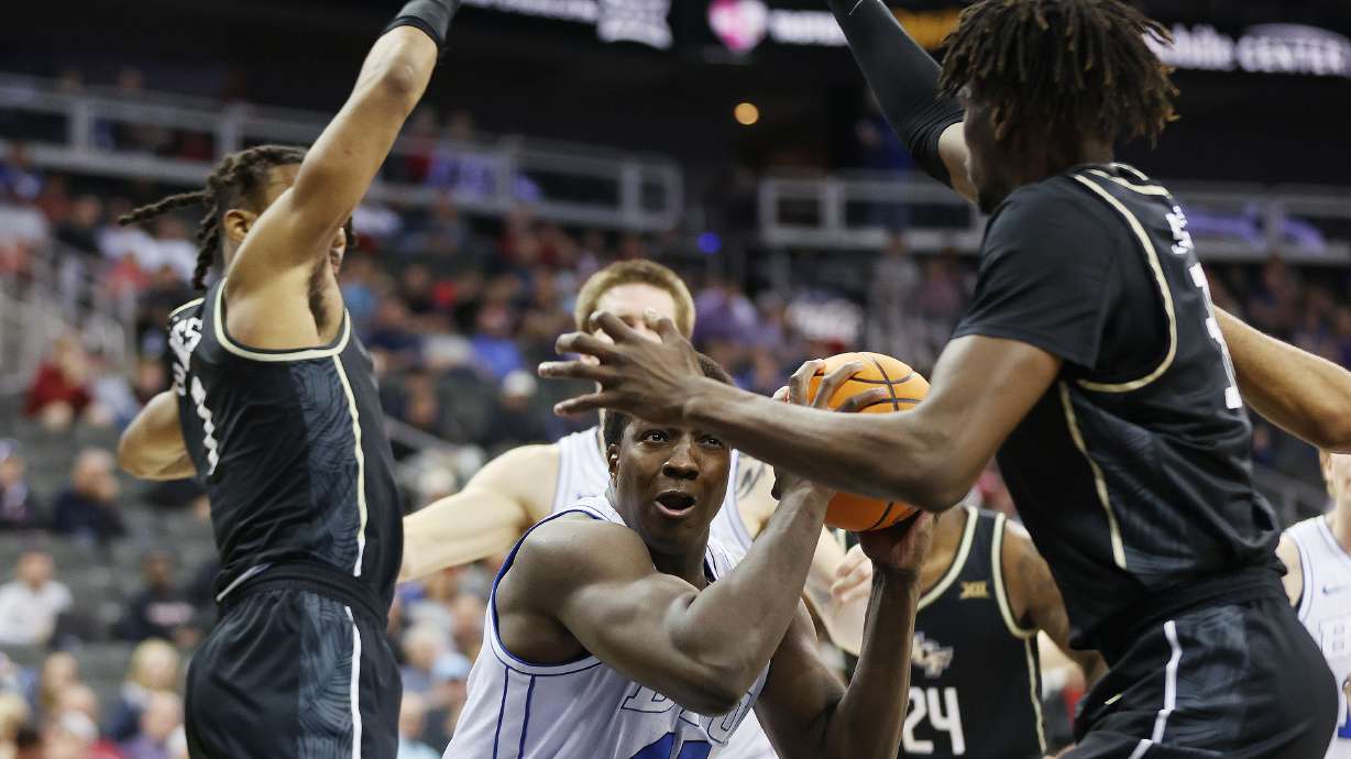 Brigham Young forward Fousseyni Traore (45) tried to shoot over UCF Knights' forward Thierno Sylla (31) during the Big 12 Conference tournament in Kansas City, Missouri on Wednesday, March 13, 2024.