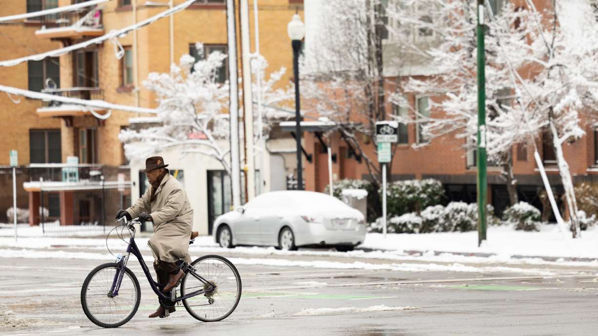 A man rides a bicycle in Salt Lake City on March 3. Snow is expected to persist in southern Utah on Thursday and Friday, while northern Utah deals with strong winds tied to a "cutoff low" in the state.