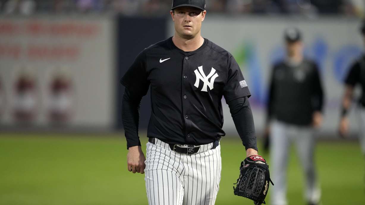 New York Yankees starting pitcher Gerrit Cole walks to the field before a spring training baseball game against the Toronto Blue Jays Friday, March 1, 2024, in Tampa, Fla.