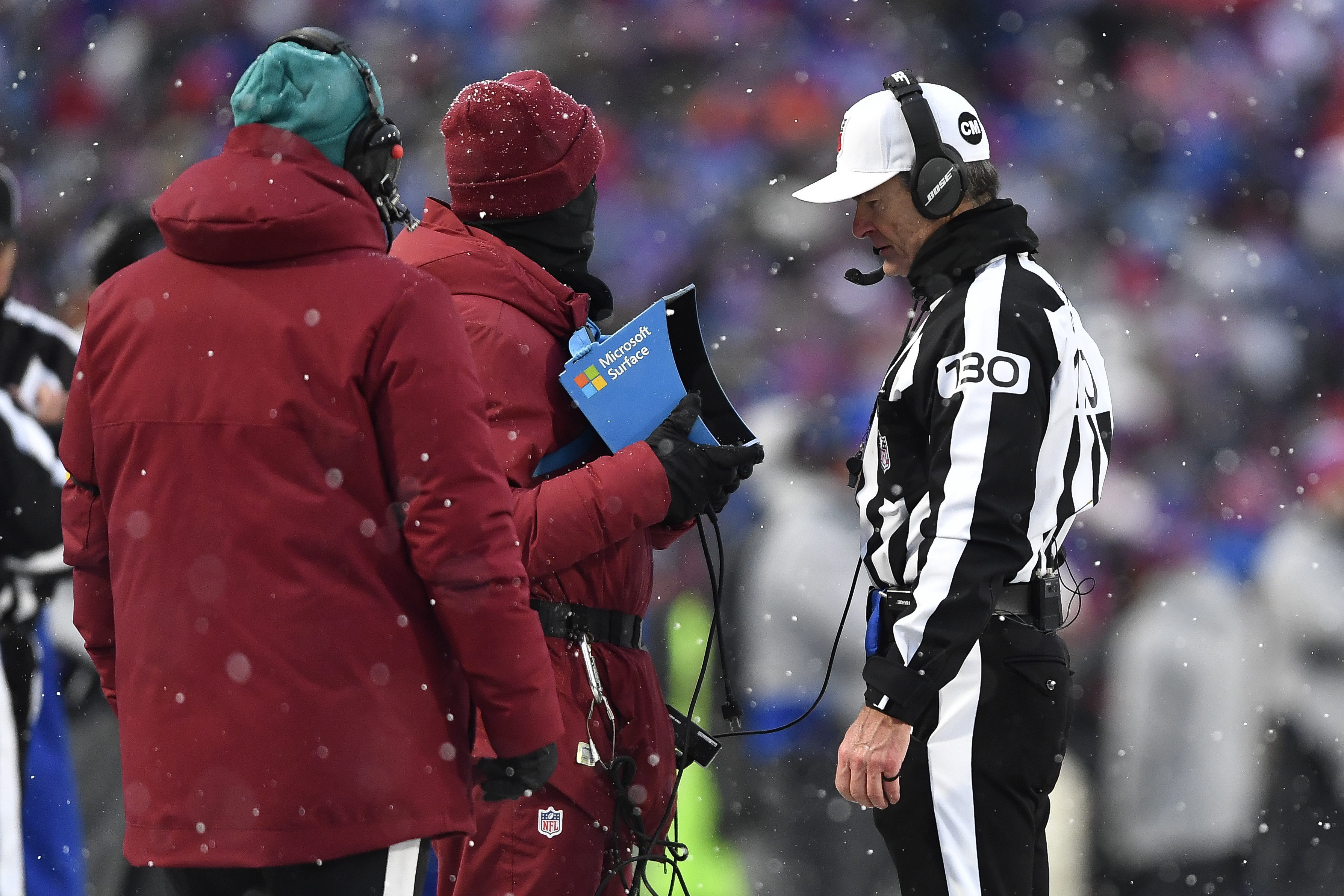 FILE - Referee Land Clark reviews a play during the second half of an NFL football game between the Buffalo Bills and the Atlanta Falcons in Orchard Park, N.Y., Jan. 2, 2022. The Indianapolis Colts are proposing a rule change that would allow for challenges of penalty calls in the last two minutes of the half. The NFL released a list of several rule change proposals Wednesday, March 13, made by teams. 
