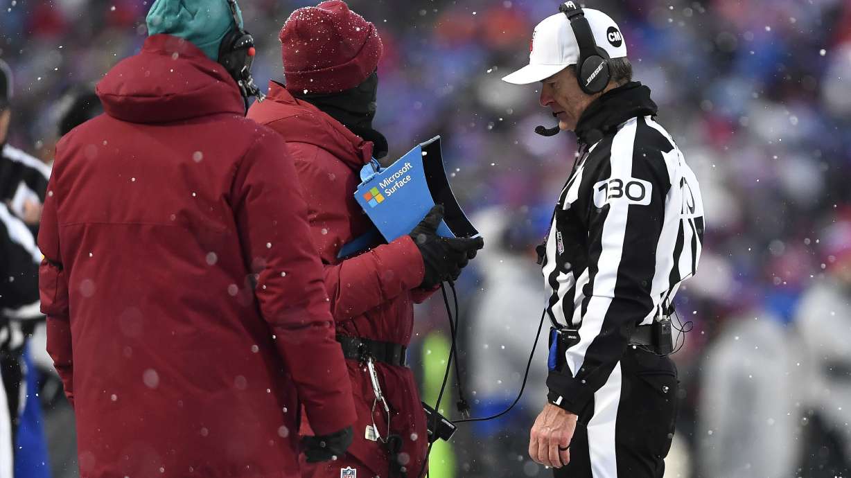FILE - Referee Land Clark reviews a play during the second half of an NFL football game between the Buffalo Bills and the Atlanta Falcons in Orchard Park, N.Y., Jan. 2, 2022. The Indianapolis Colts are proposing a rule change that would allow for challenges of penalty calls in the last two minutes of the half. The NFL released a list of several rule change proposals Wednesday, March 13, made by teams.