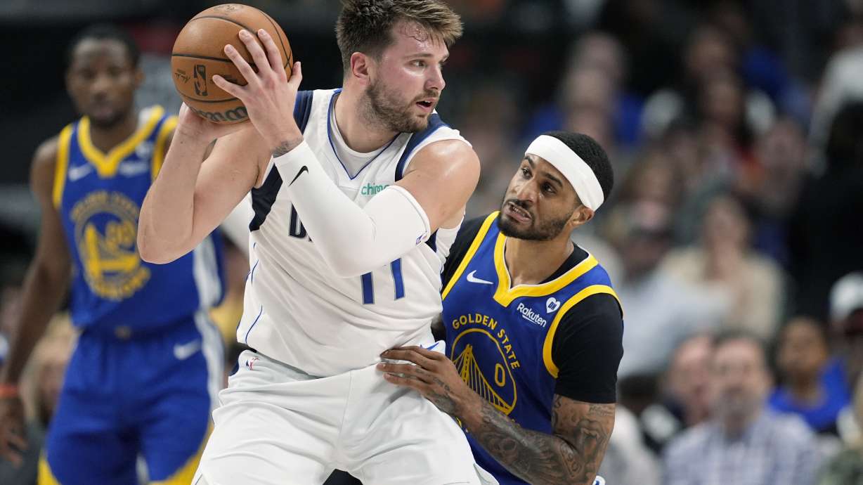 Dallas Mavericks' Luka Doncic works againts Golden State Warriors guard Gary Payton II (0) during the first half of an NBA basketball game in Dallas, Wednesday, March 13, 2024.
