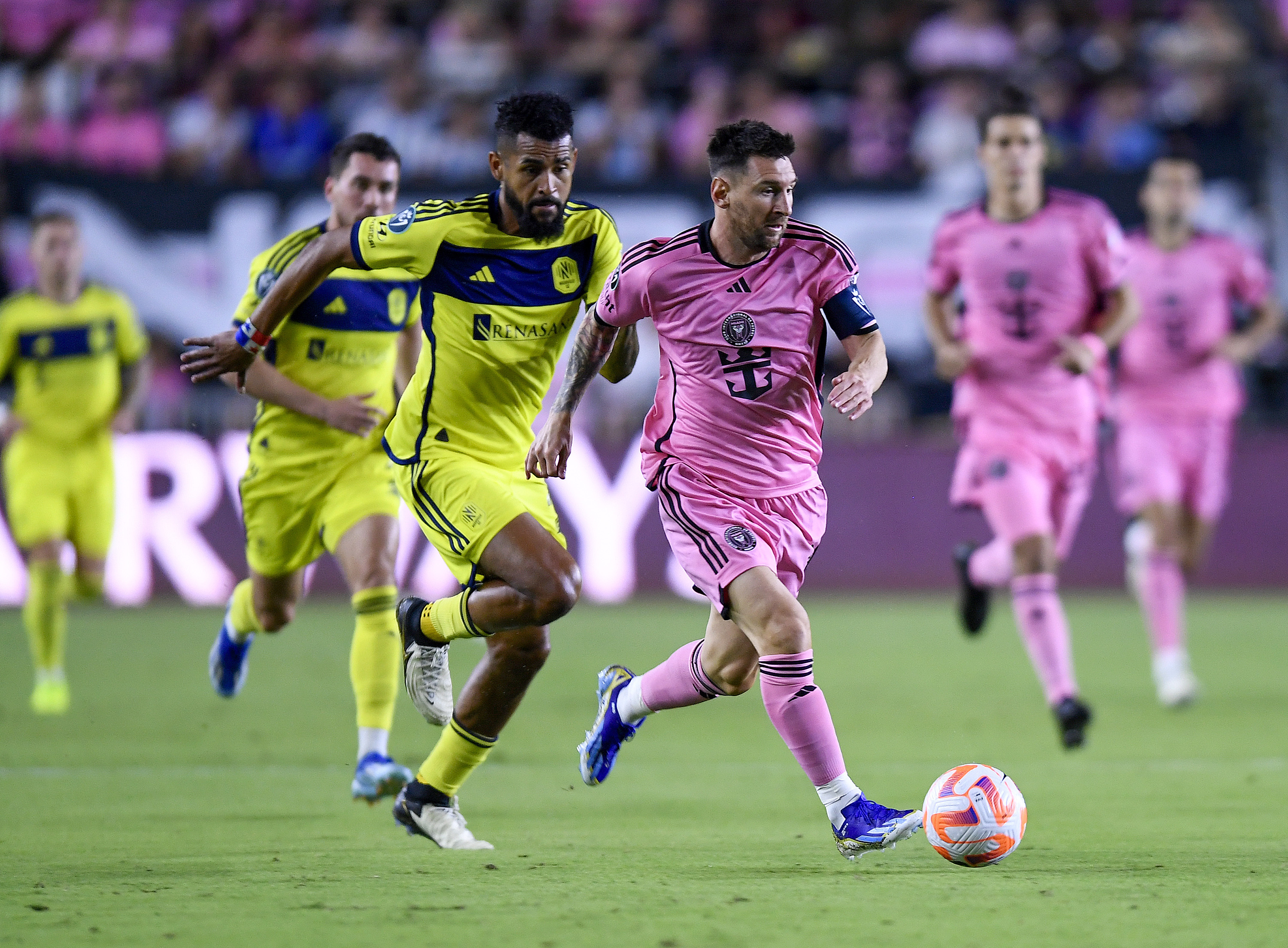 Inter Miami forward Lionel Messi races ahead of Nashville SC midfielder Anibal Godoy during the first half of a CONCACAF Champions Cup soccer match Wednesday, March 13, 2024, in Fort Lauderdale, Fla.