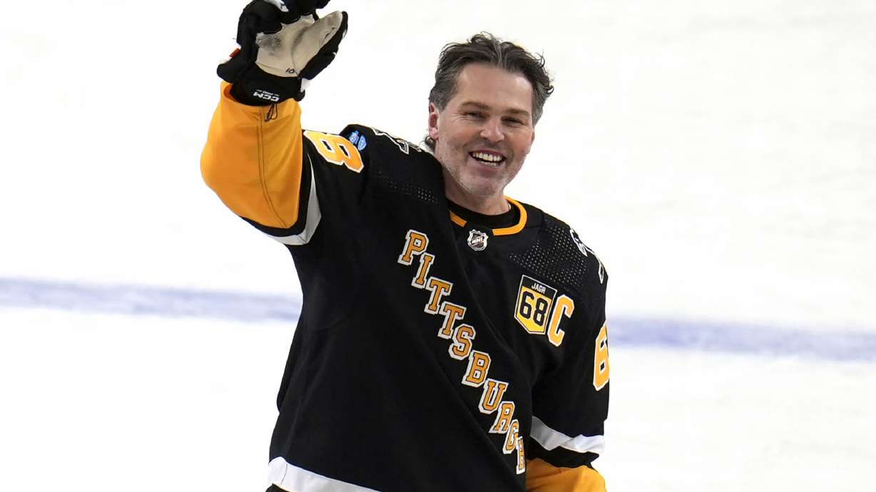 FILE - Former Pittsburgh Penguins player Jaromir Jagr stands at center ice and waves to fans after skating during warm ups after having a banner with his retired uniform number raised to the rafters of PPG Paints arena before an NHL hockey game between the Los Angeles Kings and the Penguins in Pittsburgh, Sunday, Feb. 18, 2024. Jaromir Jagr is missing. Well, the bobbleheads of the former NHL star are anyway. The Pittsburgh Penguins announced Thursday, March 14 that a shipment carrying bobbleheads of the franchise icon was stolen after arriving in California. The team had intended to give the bobbleheads away to fans during Thursday night's game against the San Jose Sharks.