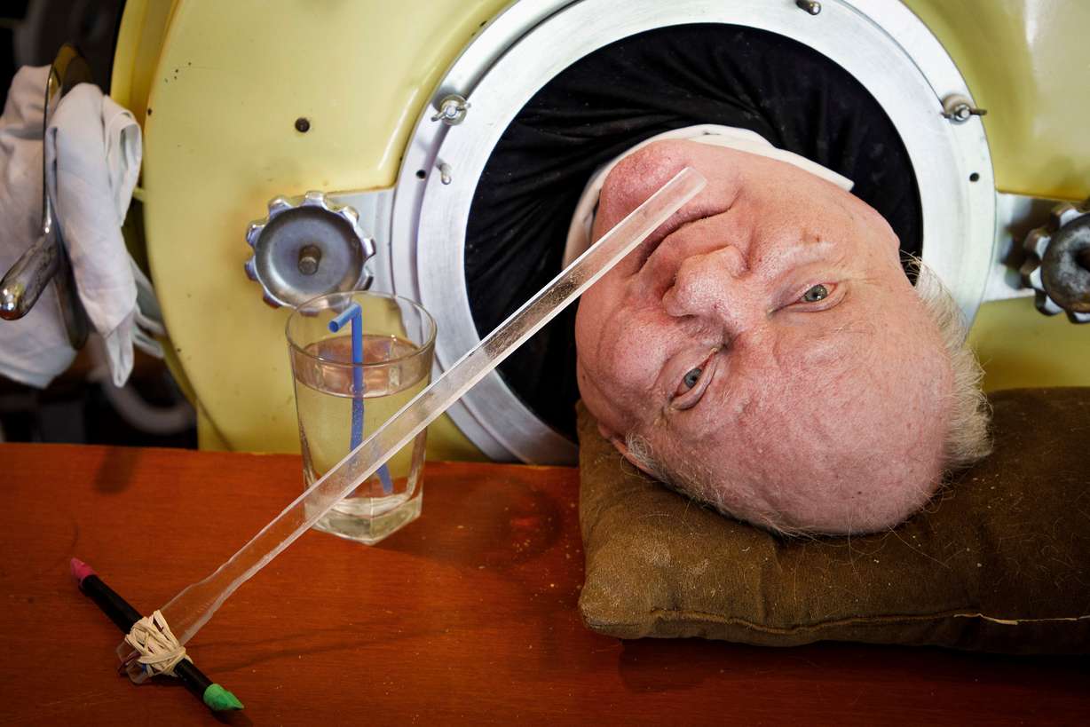 In this April 27, 2018, photo, attorney Paul Alexander looks out from inside his iron lung at his home in Dallas. Alexander died Monday at a Dallas hospital, said Daniel Spinks, a longtime friend.