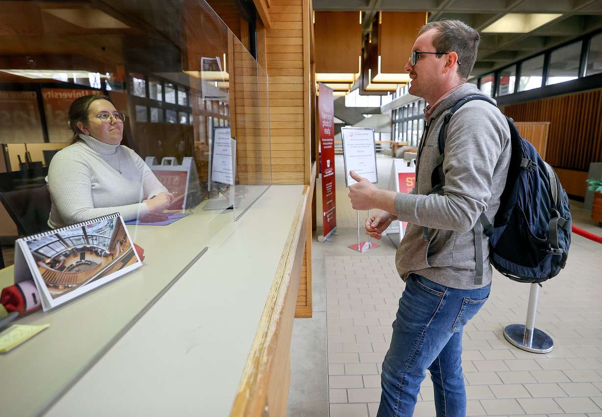 Andrea Morse, University of Utah scholarship program coordinator, left, helps Isaac Denison with a scholarship question at the Financial Aid Office at the University of Utah in Salt Lake City on Wednesday. Denison has also applied for federal student aid.