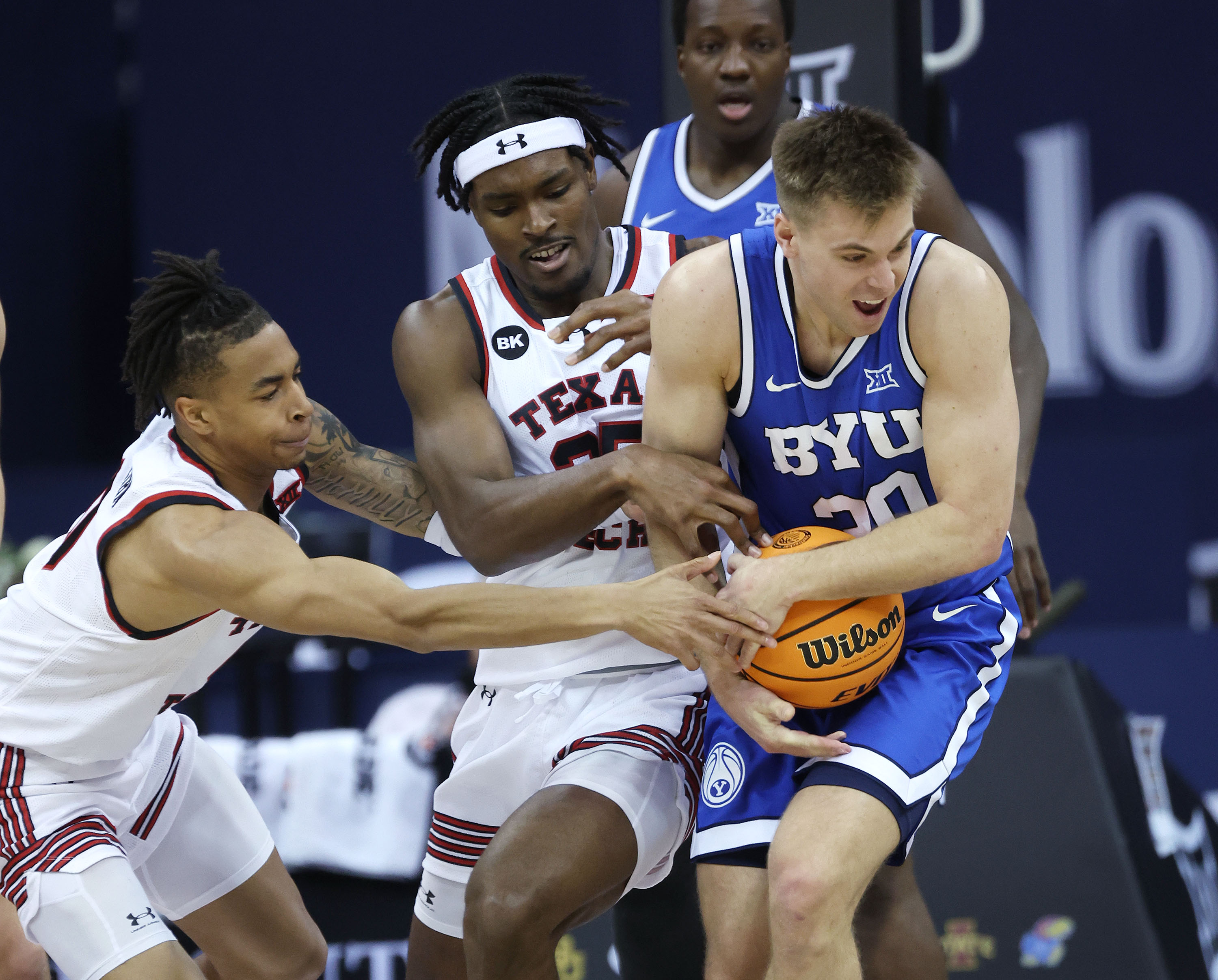 Brigham Young guard Dallin Hall (30) fights for the ball with Texas Tech forward Robert Jennings (25) during the Big 12 conference championship in Kansas City on Thursday, March 14, 2024.