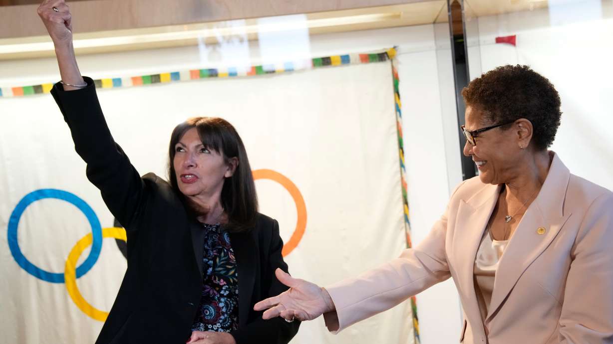 Paris Mayor Anne Hidalgo, left, speaks with Los Angeles Mayor Karen Bass at the Paris City Hall on March 7. Bass came away with a "bracing reality check" in talking with Hidalgo.