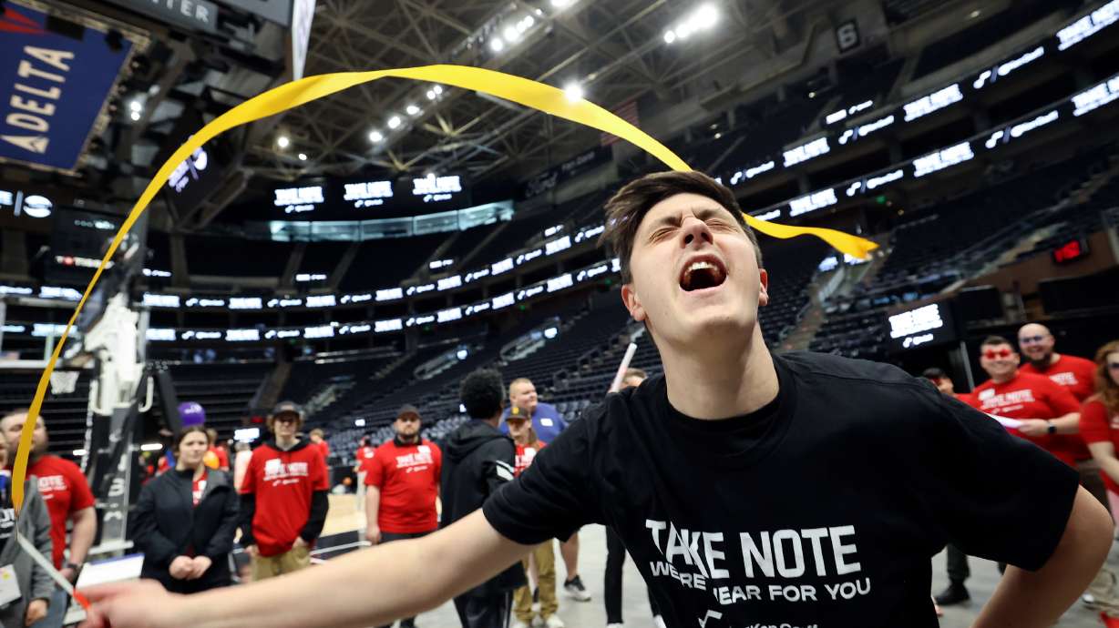 Brighton Gibson dances during an event for TURN Community Services' Utah County day program participants at the Delta Center in Salt Lake City on Thursday.
