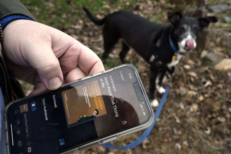 Casey Rosseau prepares to walk his dog Darcy while listening to an e-book in West Hartford, Conn., Feb. 1.