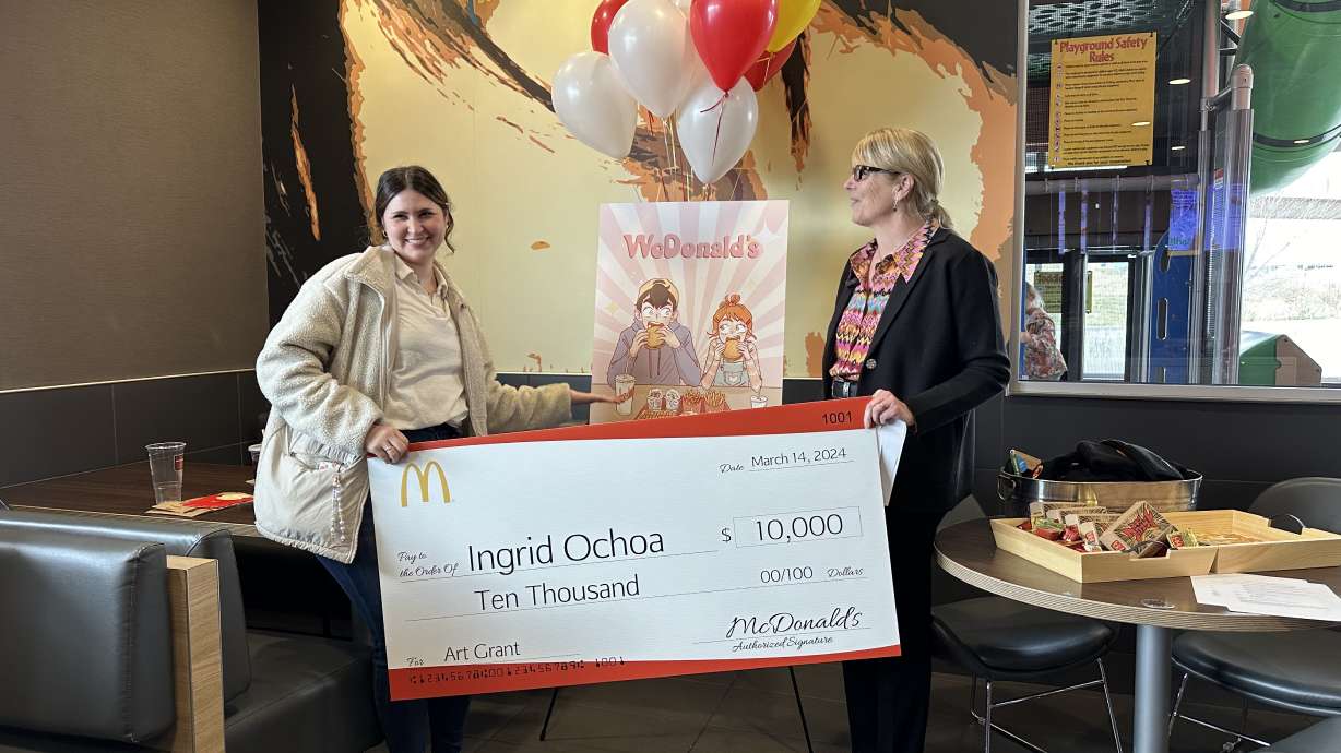 Lehi artist Ingrid Ochoa, 34, shows off the "WcDonald's" anime artwork that won her a $10,000 grant from McDonald's on Thursday in Lehi.