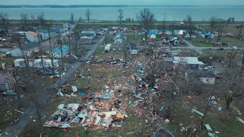 Damage from tornadoes is revealed in the morning light after tornadoes ripped through the Indian Lake area of Logan County, Ohio, Friday.