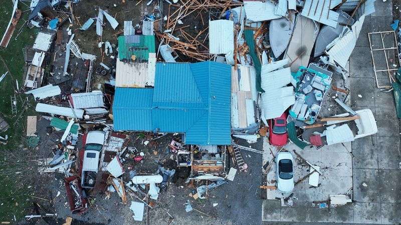 Damage from tornadoes is revealed in the morning light after tornadoes ripped through the Indian Lake area of Logan County, Ohio, Friday.