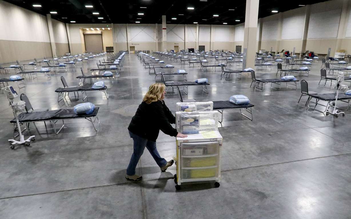 Jan Robinette, an emergency medical technician with the Utah Health Emergency Response Team, pushes an isolation cart inside the Mountain America Expo Center in Sandy on April 6, 2020.