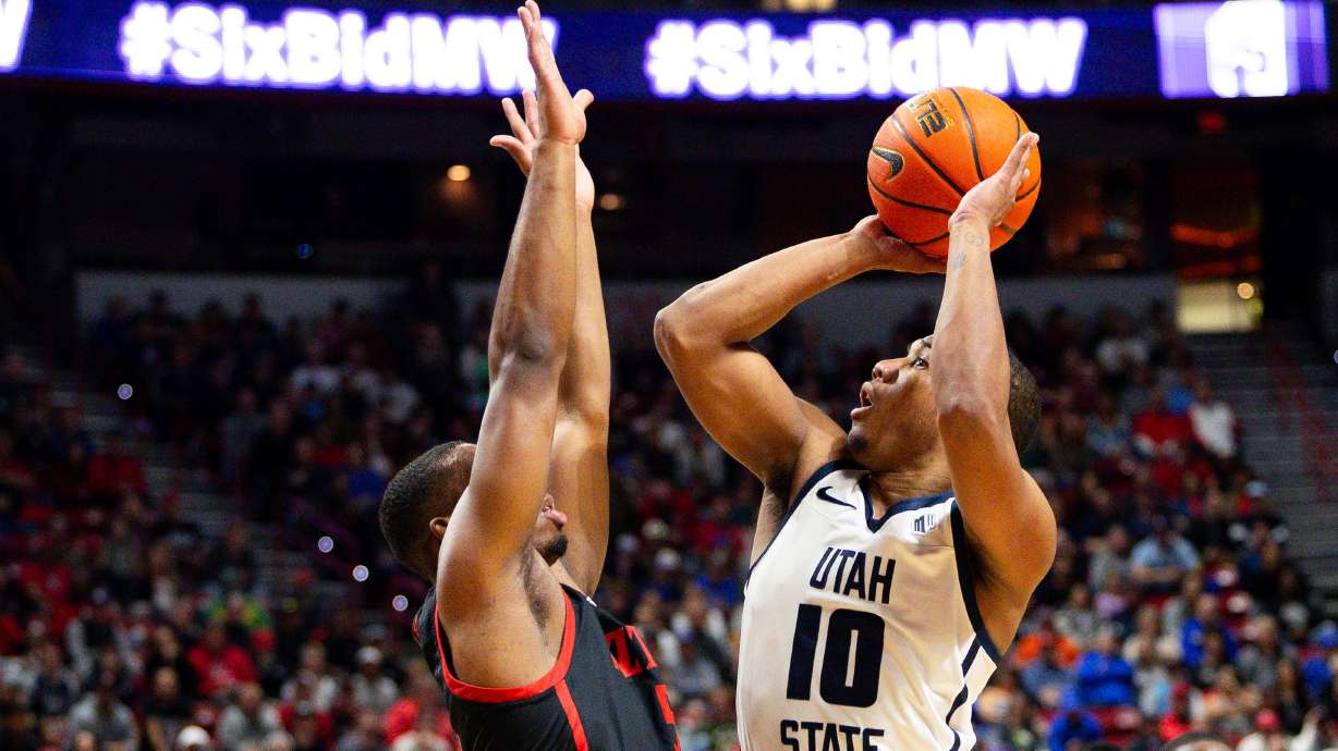 Utah State Aggies guard Darius Brown II (10) shoots the ball with San Diego State Aztecs guard Lamont Butler (5) on defense during the game between the Utah State Aggies and the San Diego State Aztecs in the semifinals of the Mountain West 2024 Men's Basketball Championship at the Thomas & Mack Center in Las Vegas on Friday, March 15, 2024.