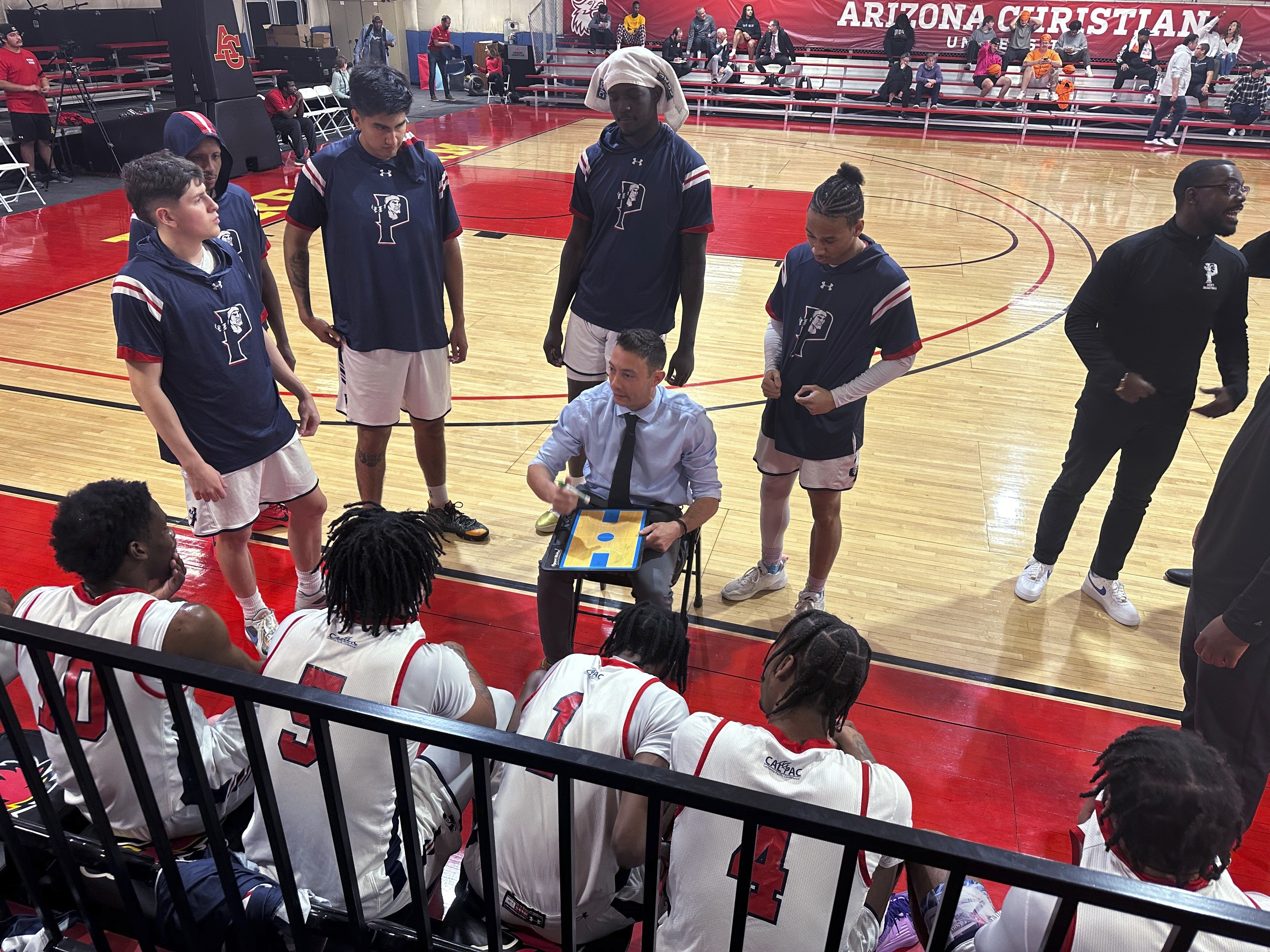Antelope Valley coach Jordan Mast talks with his team during a timeout during a first-round game against Huntington (Indiana) in the NAIA men's basketball tournament Friday, March 15, 2024, in Glendale, Ariz. Antelope Valley lost 85-71 to end the season with a 26-5 record. Now they'll head back to California with no college to return to, but with their heads held high after the group persevered through a few uncertain months. 
